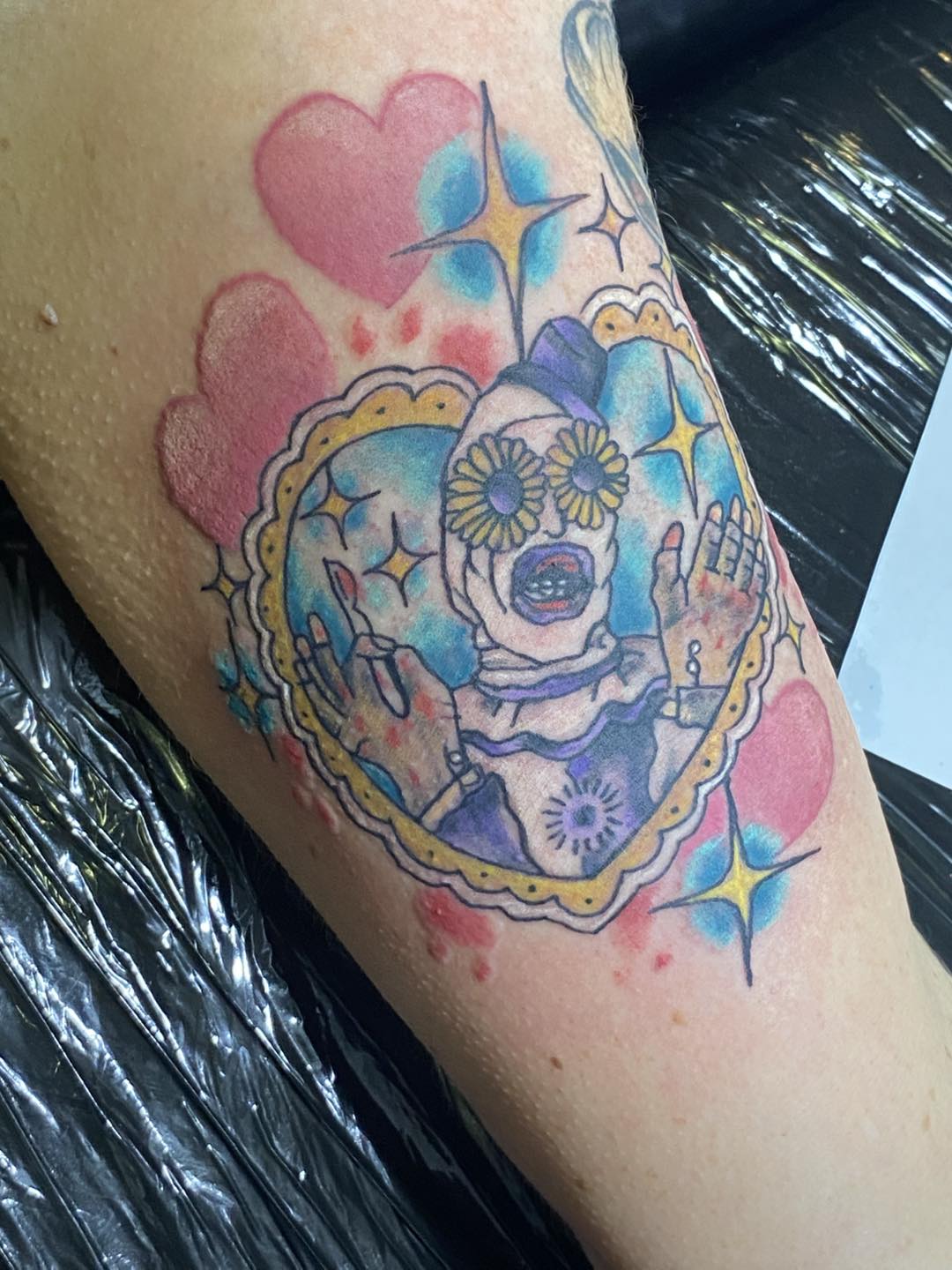 daisy eyed art the clown from terrifier done in a colorful heart shaped frame surrounded by more hearts 